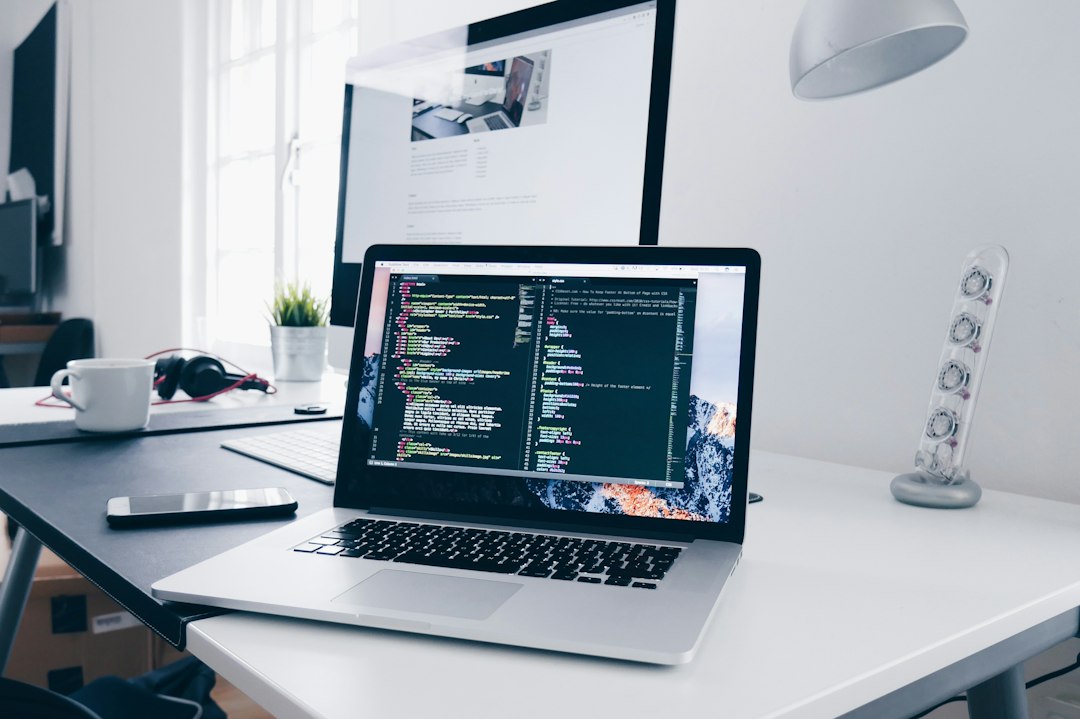 Photo of a laptop with code on screen